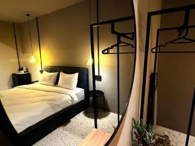 a bedroom with a bed and a mirror at M2 Living Townhouse in Ipoh in Ipoh