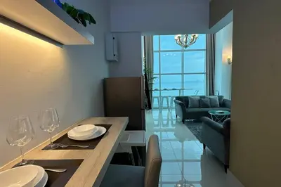 a living room with a table and a dining room at Seaview Seafront Duplex in Town with WiFi & Full Kitchen 66 in Georgetown