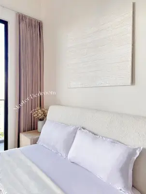 a bedroom with a white bed with a picture above it at Beacon Georgetown Skypool Cityview Free 2 Carpark in George Town