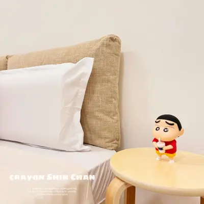 a toy man standing on a table next to a bed at Beacon Georgetown Skypool Cityview Free 2 Carpark in George Town
