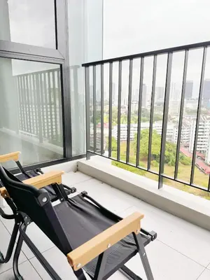 a room with two chairs in front of a large window at Beacon Georgetown Skypool Cityview Free 2 Carpark in George Town