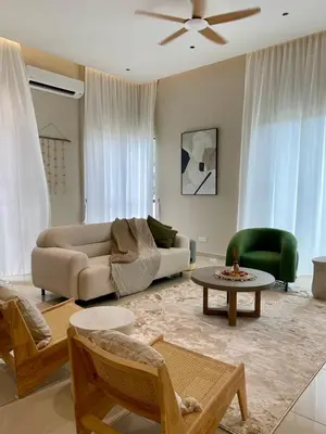 a living room with a couch and a table at Serenity Haven in Sungai Besar
