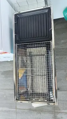 a dog in a cage sitting on the floor at Serenity Haven in Sungai Besar