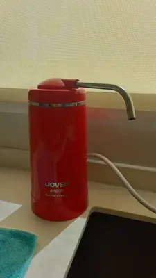 a red can sitting on a desk next to a window at Serenity Haven in Sungai Besar