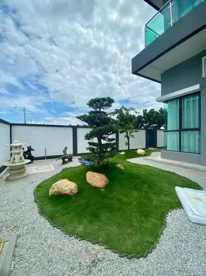 a garden with a bonsai tree in the middle of a building at Serenity Haven in Sungai Besar