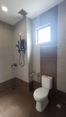 a bathroom with a toilet and a phone on the wall at Serenity Haven in Sungai Besar