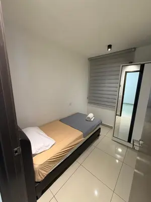 a small bedroom with a bed and a mirror at The Majestic Ipoh 3BR - Goswell in Ipoh