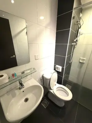 a bathroom with a white toilet and a sink at The Majestic Ipoh 3BR - Goswell in Ipoh
