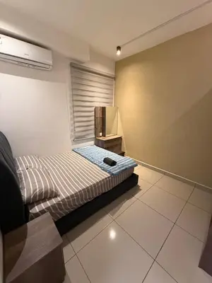 a small bedroom with a bed and a television at The Majestic Ipoh 3BR - Goswell in Ipoh