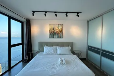 a bedroom with a bed with white shoes on it at Seaview Premium Duplex in Gurney with WiFi & Full Kitchen 12B in George Town