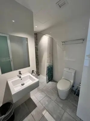 a bathroom with a sink and a toilet at Seaview Premium Duplex in Gurney with WiFi & Full Kitchen 12B in George Town