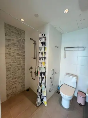 a bathroom with a toilet and a shower at Seaview Premium Duplex in Gurney with WiFi & Full Kitchen 12B in George Town