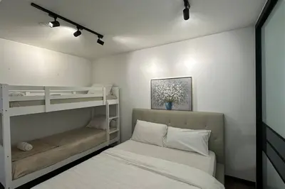 a bedroom with two bunk beds and a bed at Seaview Premium Duplex in Gurney with WiFi & Full Kitchen 12B in George Town