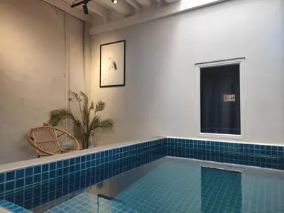 a swimming pool in a room with blue tile at Heritage House 2BR with Dipping Pool in Town walkto Street Art 45 in George Town