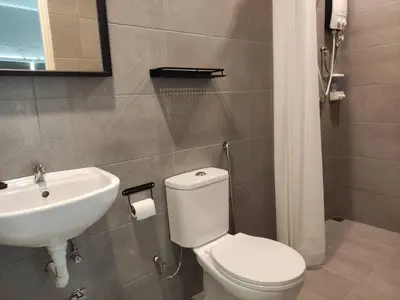 a bathroom with a white toilet and a sink at Heritage House 2BR with Dipping Pool in Town walkto Street Art 45 in George Town