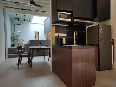 a kitchen with a sink and a table with a microwave at Heritage House 2BR with Dipping Pool in Town walkto Street Art 45 in George Town