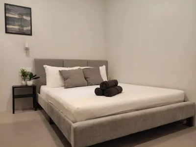 a bed with two brown towels on top of it at Heritage House 2BR with Dipping Pool in Town walkto Street Art 47 in George Town
