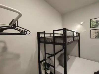 a black bunk bed in a room with a wall at Heritage House 2BR with Dipping Pool in Town walkto Street Art 47 in George Town