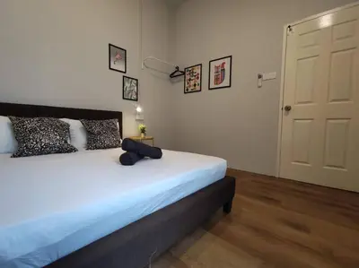 a bedroom with a bed and a white door at Heritage House 2BR in Town walkto UNESCO Site & StreetArt 45 in George Town