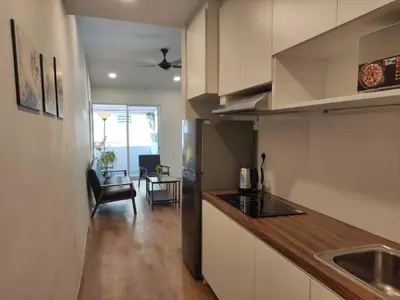 a kitchen with a counter top and a living room at Heritage House 2BR in Town walkto UNESCO Site & StreetArt 45 in George Town