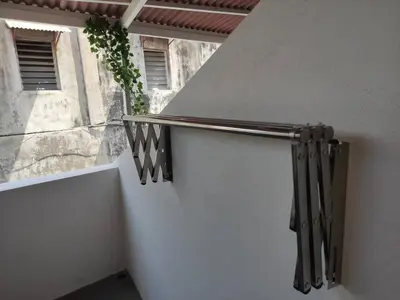 a stair railing with a plant on the side of a building at Heritage House 2BR in Town walkto UNESCO Site & StreetArt 45 in George Town
