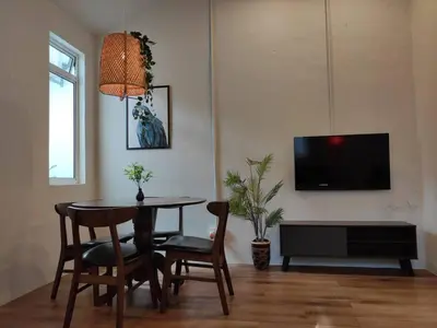 a living room with a table and chairs and a tv at Heritage House 3BR in Town walkto UNESCO Site & StreetArt 47 in George Town