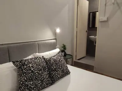 a bedroom with a bed with two pillows on it at Heritage House 3BR in Town walkto UNESCO Site & StreetArt 47 in George Town