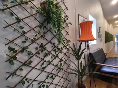a wall covered in ivy with a table and a lamp at Heritage House 3BR in Town walkto UNESCO Site & StreetArt 47 in George Town