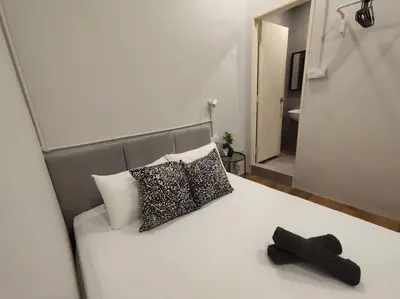 a bed with two pillows and a black hat on it at Heritage House 3BR in Town walkto UNESCO Site & StreetArt 47 in George Town
