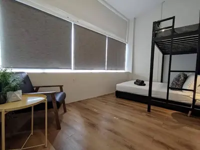 a room with a bed and a table and a window at Heritage House 3BR in Town walkto UNESCO Site & StreetArt 47 in George Town