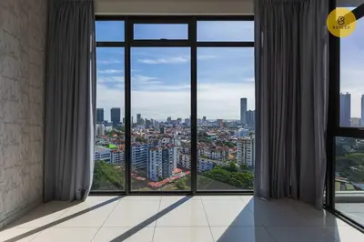 a room with a large window with a view of a city at Seaview 2BR Infinity Pool & EasyAccess to Town 13A in George Town
