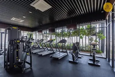 a gym with a row of treadms and cardio machines at Seaview 2BR Infinity Pool & EasyAccess to Town 13A in George Town