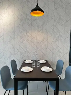 a dining table with blue chairs and aendant light at Seaview 2BR Infinity Pool & EasyAccess to Town 13A in George Town