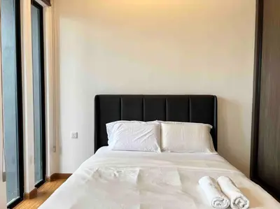 a bed with two white towels on top of it at Greatview 2BR Infinity Pool & EasyAccess to Town 13 in George Town