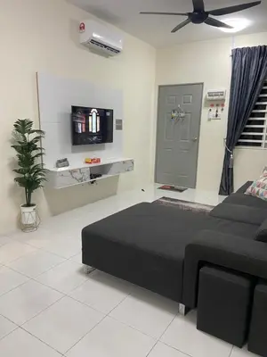 a bedroom with a black bed and a flat screen tv at Homestay RumahKita di Seri Iskandar in Seri Iskandar
