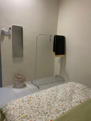 a room with a bed with a mirror and a bed sidx sidx sidx at Homestay RumahKita di Seri Iskandar in Seri Iskandar