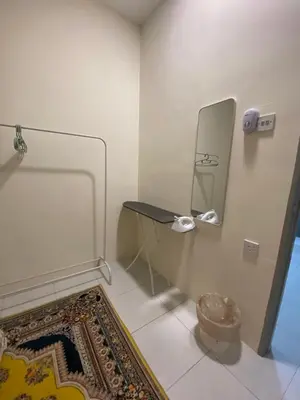 a room with a table and a mirror and a rug at Homestay RumahKita di Seri Iskandar in Seri Iskandar