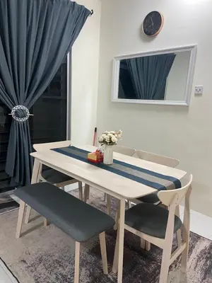 a table and two chairs with a table and a window at Homestay RumahKita di Seri Iskandar in Seri Iskandar