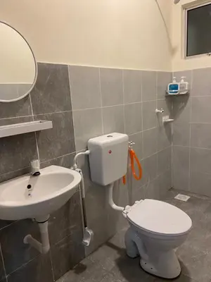 a bathroom with a toilet and a sink at Homestay RumahKita di Seri Iskandar in Seri Iskandar