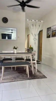 a dining room with a table and benches at Homestay RumahKita di Seri Iskandar in Seri Iskandar