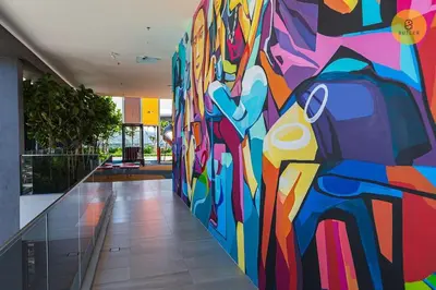 a large painting on a wall in a hallway at Seaview 2BR Infinity Pool & EasyAccess to Town 201 in George Town