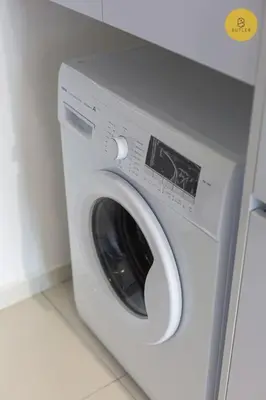a white washing machine in a room with a counter at Seaview 2BR Infinity Pool & EasyAccess to Town 201 in George Town
