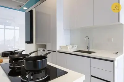 a white kitchen with two pots on a stove at Seaview 2BR Infinity Pool & EasyAccess to Town 201 in George Town