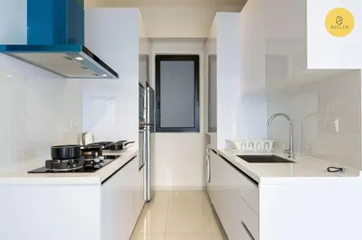 a white kitchen with a sink and a refrigerator at Seaview 2BR Infinity Pool & EasyAccess to Town 201 in George Town