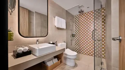 a bathroom with a sink and a toilet and a shower at Holiday Inn & Suites Penang Prai by IHG in Bukit Mertajam