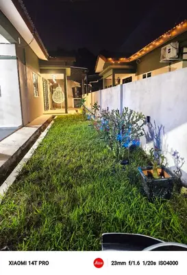 a yard of a house at night with plants at Homestay Iman Seri Iskandar Uitm Perak Utp in Seri Iskandar