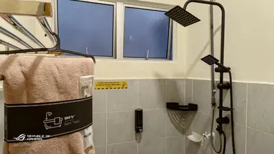a bathroom with a shower and a window at Homestay Iman Seri Iskandar Uitm Perak Utp in Seri Iskandar