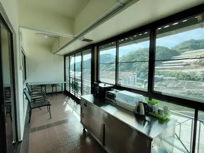 a kitchen with a counter with a view of a mountain at The Family Hideaway 2 Bedroom Apartment at Equatorial Hill Resort in Brinchang