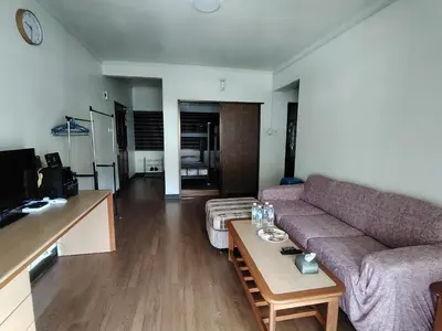 a living room with a couch and a table at The Family Hideaway 2 Bedroom Apartment at Equatorial Hill Resort in Brinchang