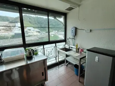 a kitchen with a sink and a large window at The Family Hideaway 2 Bedroom Apartment at Equatorial Hill Resort in Brinchang